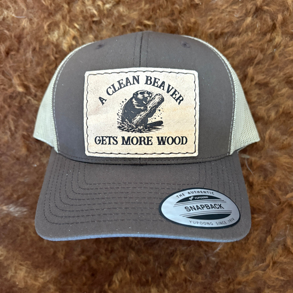 Gray and green cap with a Clean Beaver patch on a brown textured background