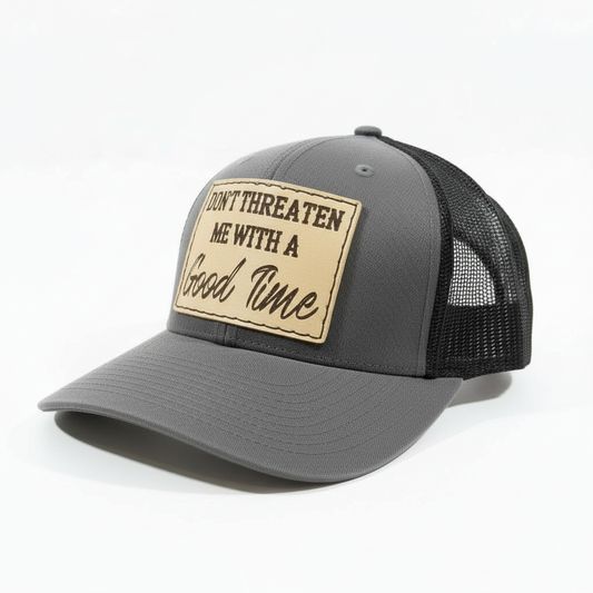 Brown and beige cap with a patch saying 'Don't threaten me with a good time' on a white background