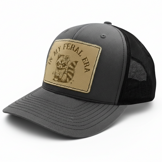 Gray and black cap with a brown patch featuring text and graphics on a white background