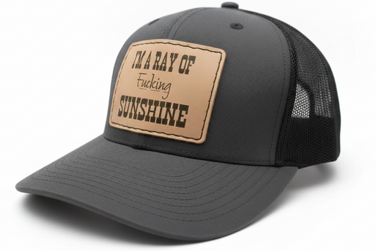 Black trucker cap with a brown leather patch on a light gray background