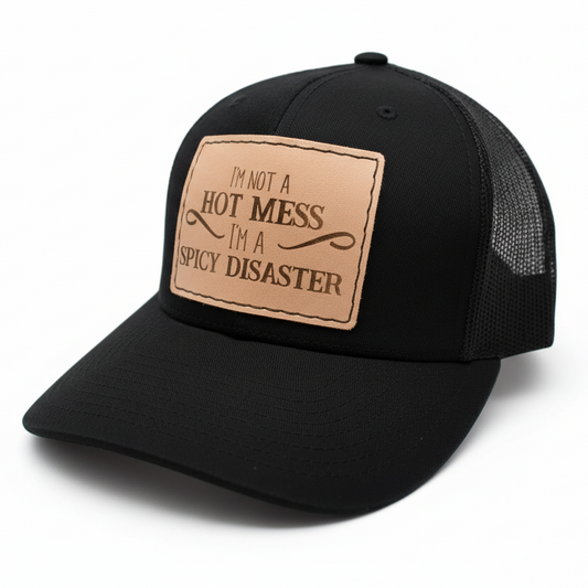 Black cap with a brown leather patch featuring text on a white background