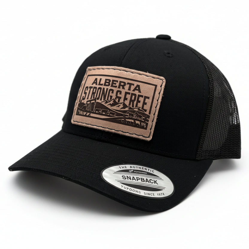 Black trucker cap with 'Alberta Strong & Free' leather patch on a light gray background