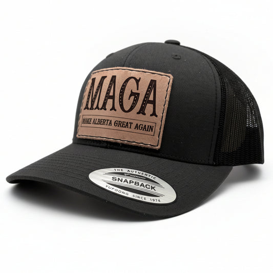 Black trucker cap with 'MAGA Make Alberta Great Again' patch on a gray background