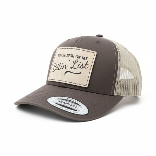 brown hat with a leather hat patch that says you're high on my bitin' list