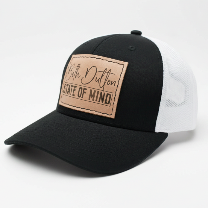 Black and white cap with a brown leather patch on a light gray background