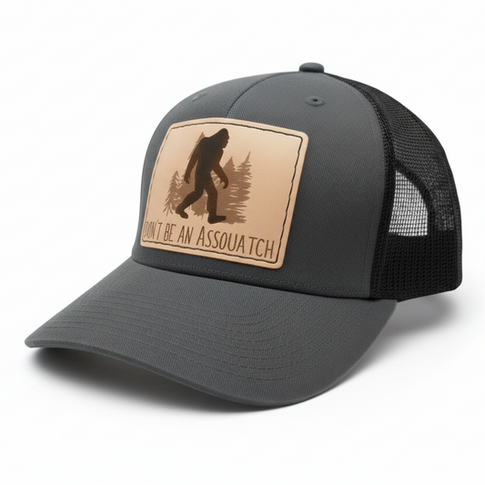 Gray and black cap with a leather patch featuring a Sasquatch design on a white background