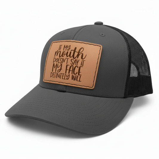 Gray trucker cap with brown leather patch on a white background