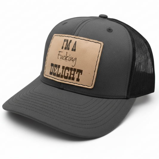 Gray trucker cap with a brown leather patch on a light gray background