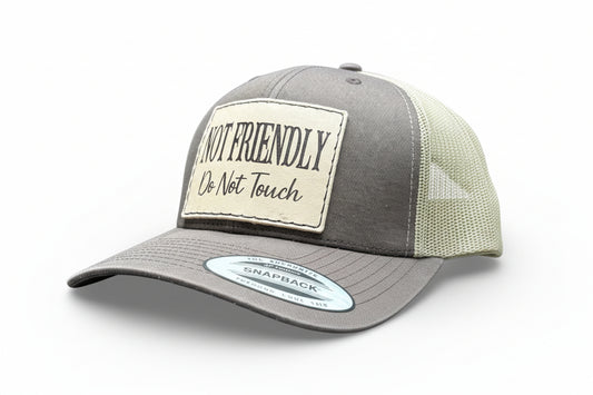 brown and khaki cap with 'Not Friendly Do Not Touch' patch on a white background