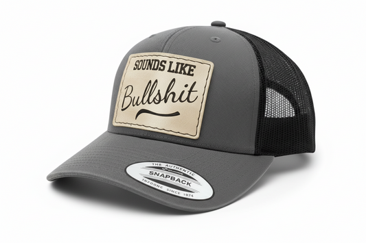 Black snapback cap with a beige patch and text on a white background