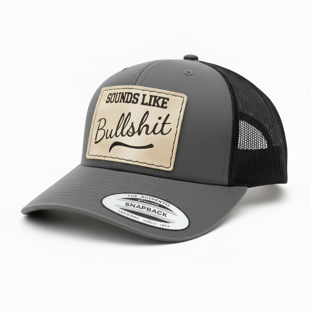 Black snapback cap with a beige patch and text on a white background