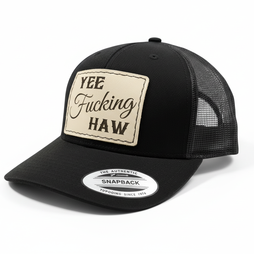 black trucker cap with a leather patch and brand logo on a white background